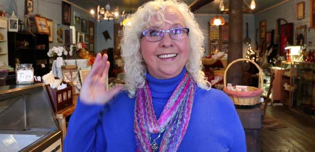 Woman smiling at camera waving