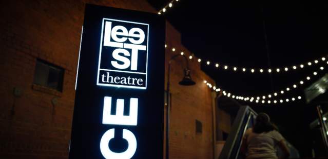 Lee St. Theater Sign lit up at night