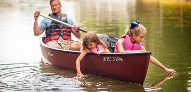 Little girls and dad in canoe