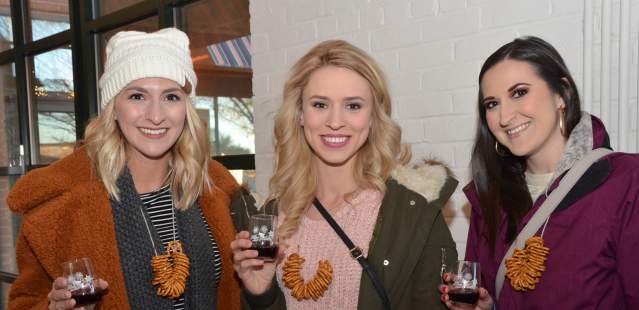 Three women tasting wine at Wine About Winter