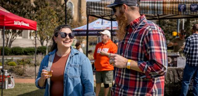 Couple smiling with each other at beer festival