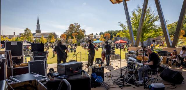 Band performing on stage at outdoor ampitheatre