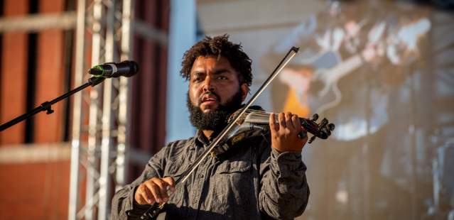 Violinist in front of Bell Tower