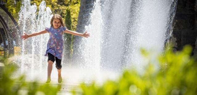 Girl playing in water at Bell Tower Green