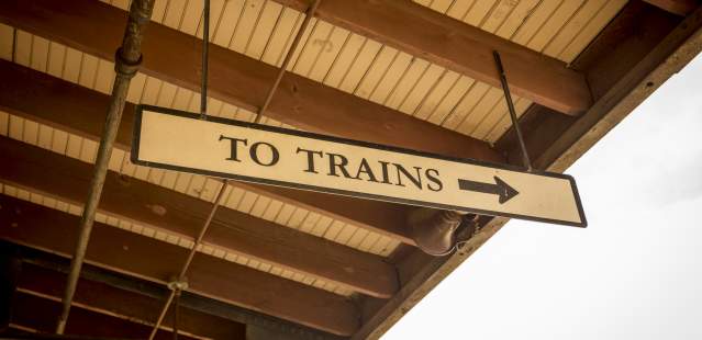 "To Trains" sign at train station