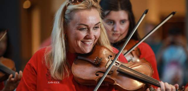 Blonde woman playing the violin