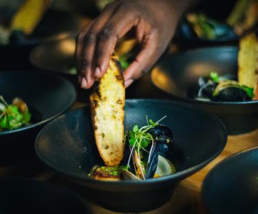 UGK Culinary Director Steve Glenn's mussels and scallops met with a charred crustini.