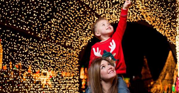 child pointing at Christmas lights