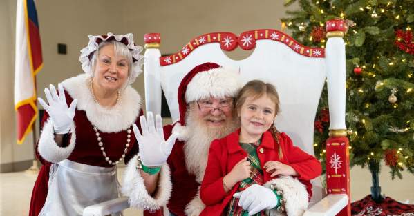 child meeting Santa Claus and Mrs. Claus