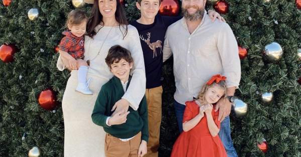 family in front of Christmas tree