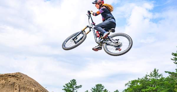 Lady on mountain bike in the air