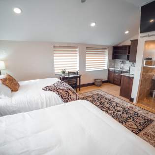 Interior of a hotel room with two beds at Iron Springs Resort in Cedar City, UT