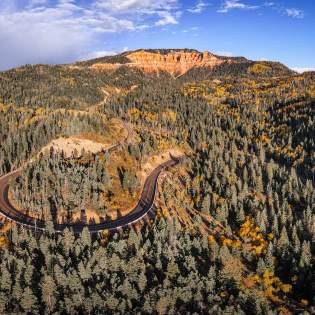Aerial views of the "False Breaks" in Cedar Canyon with fall color blended with towering pine trees along the scenic drive