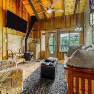Cozy interior of a wood cabin with woodburning stove and comfortable furniture