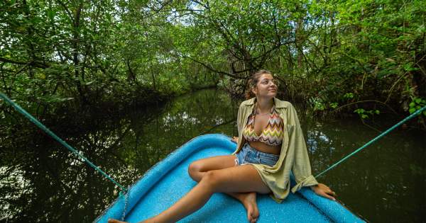 Woman on a boat admiring the nature on Bastimentos National Marine Park