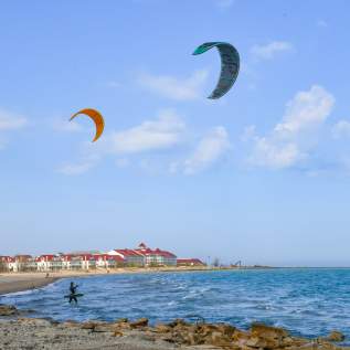 People flying kites on the beach