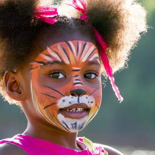 Young girl with face painted at downtown event