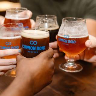 People Cheering with beer at Common Bond Brewers