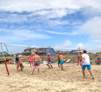 Group of guys playing beach volleyball