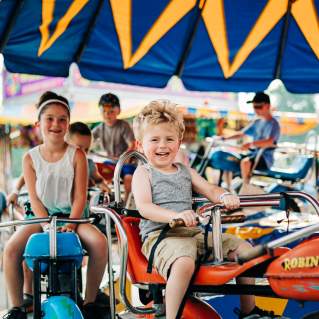 A child rides on a merry-go-round at the Allegany County Fair.