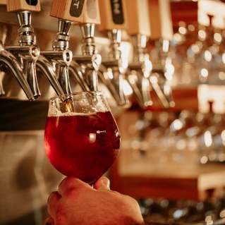 An amber beer being poured from a tap.