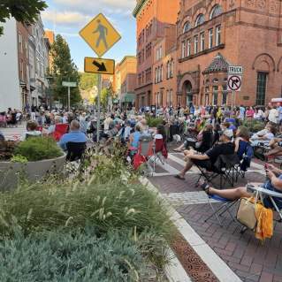 A large crowd gathers along the downtown street in Cumberland, MD, for live music at Friday After Five.