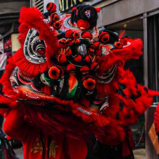 Large Red Dragon Puppet in Street During Chinese New Year Celebration in Boston