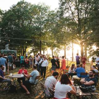 A Crowd At Owl's Nest Beer Garden In Boston, MA