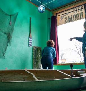 Two visitors trying to solve the Black Hills Escape Rooms Puzzle about Pactola in the Black Hills