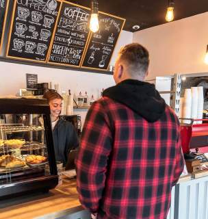 Guest ordering at the counter inside essence of coffee in downtown rapid city