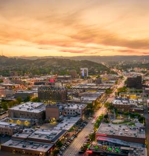 drone sunset view over rapid city with the black hills in view