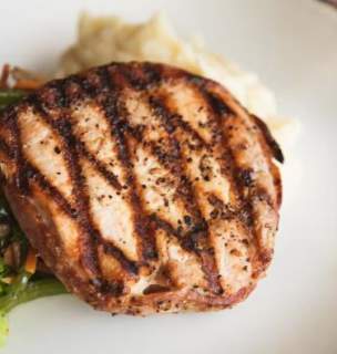 Grilled chicken on plate with brocolli.
