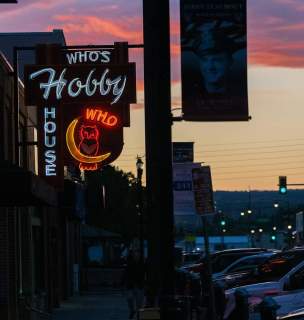 Sunset behind the neon sign of rapid city's who's hobby house 