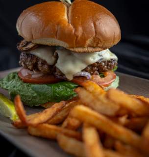 Close up image of burgers and fries.