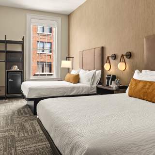 Double queen beds in a new hotel room.