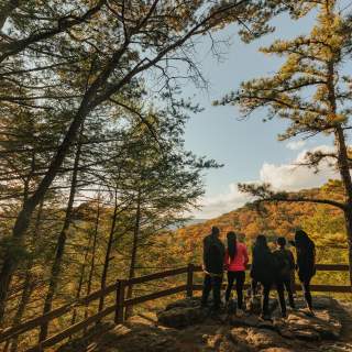 A family looks over the railing at the Canyon Overlook in Rocky Gap State Park.