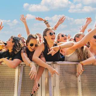 Crowd of young women against the festival barricade in front of stage at ACL Music Festival