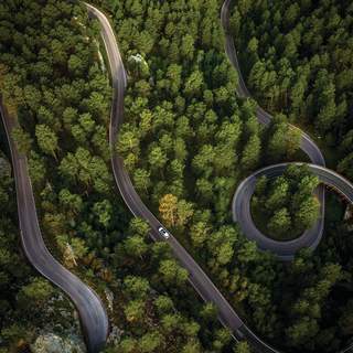 Aerial view of a car driving on Iron Mountain Road