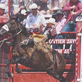 Cheyenne native Brody Cress rides a saddle bronc horse out of the chutes