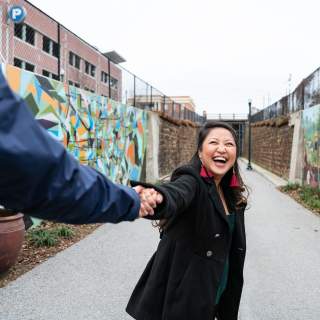 A couple has fun exploring the Vista Greenway, a popular spot to walk and look at the murals.