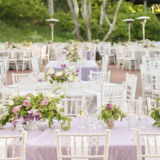Luxurious centerpieces and purple linens decorate the event tables in Creekside Terrace
