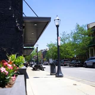 street view of downtown Mobile. Street lights and flowers.