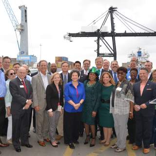 Image of elected officials and local business leaders on a Port Everglades dock during a celebration of the U.S. Army Corps of Engineers approval for harbor improvements at Port Everglades