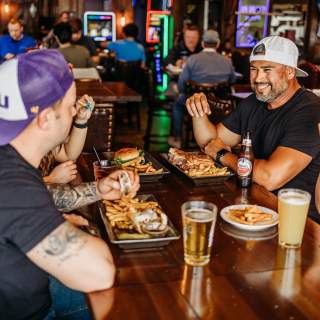a Group eating at Niko's with beers and food