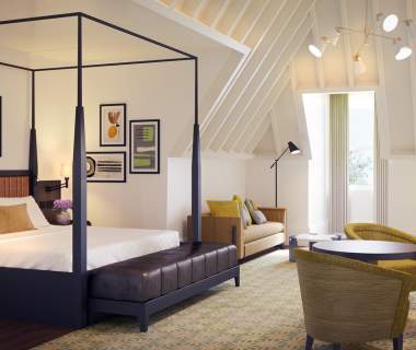 The Grand Hotel luxury suite, featuring a canopy bed, table and two chairs
