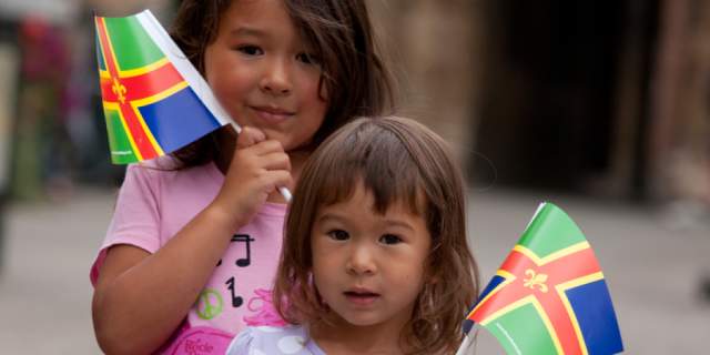 two girls holding miniature Lincolnshire flags
