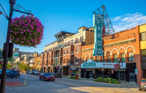 bright, spring-time photo of Fargo Theatre and Downtown Fargo