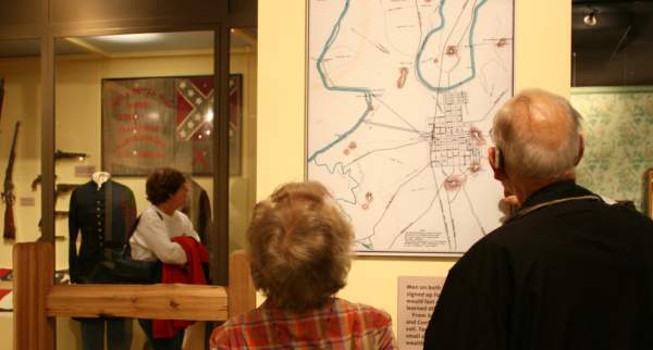 Visitors examine a map hung as part of the Civil War Exhibit at the Kentucky Museum