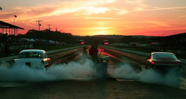 Vintage hot rods on the Beech Bend drag strip at sunset