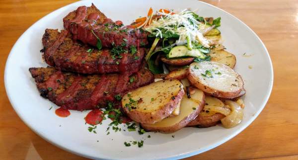 A plate of dutch-oven potatoes, steamed vegetables, and meatloaf from local restaurant Bowman's Cowboy Kitchen in Cedar City, Utah.